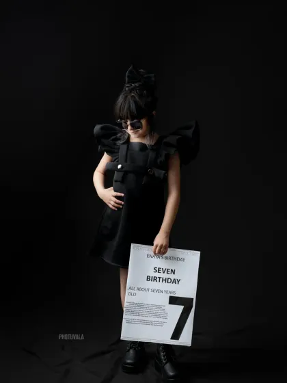 A full-length shot showing off the complete "Level 7" birthday outfit. We help style your child to perfectly match the theme, from the dress and sunglasses to the cool boots.
