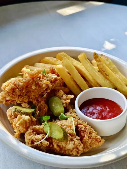 Crispy chicken tenders served with pickles and a side of fries and ketchup. A comforting classic from my secret recipe book.