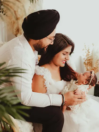 A heartwarming photo of new parents looking at their baby with so much love. This image perfectly captures the beginning of their new family journey.