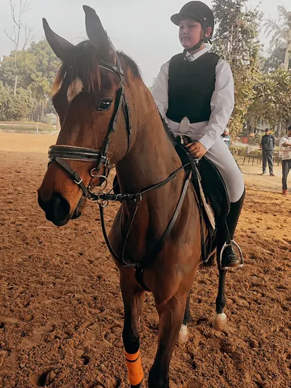 Rider Arnav and his horse Amazing Dream warming up in the arena before an event. Preparation and focus are a critical part of our training.