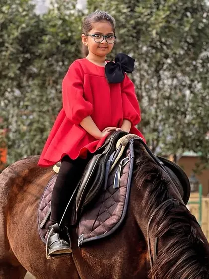Dressed up for her ride, a young girl sits gracefully on her horse. Our club is a place where kids can have fun and make lasting memories.