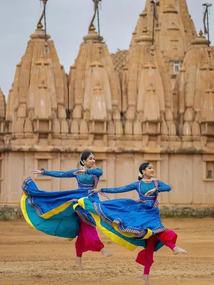 The swirl of our blue Anarkali costumes in perfect sync. This shot captures the energy and visual beauty of the Kathak spin, a key element of our performances.