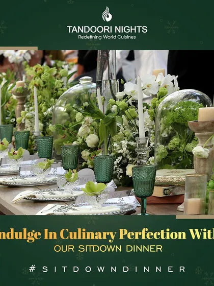 An example of our exquisite sit-down dinner table settings, featuring green glassware, silver charger plates, and fresh floral centerpieces for a truly elegant dining experience.