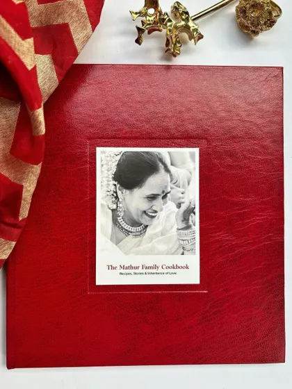 We had the honor of creating this beautiful, custom red silk-bound cookbook for the Mathur family. For corporate orders, we can weave your company's story and logo into the design, making it a truly personal and celebratory gift for your team or clients during the festive season or for special milestones.