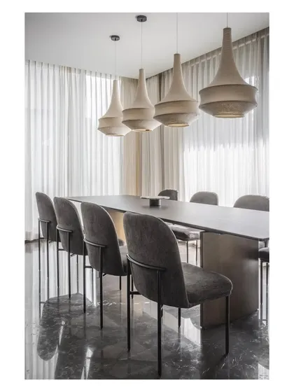 The reflection on the polished dark marble floor enhances the drama and elegance of the dining area in House 111.