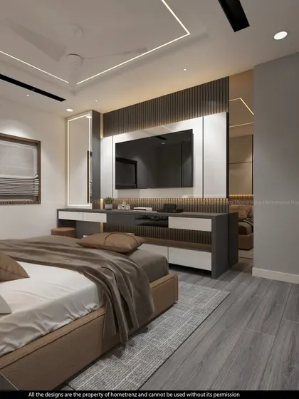 A master bedroom with a TV unit that includes a vanity table and a large, back-lit mirror. The grey wood-look flooring adds a modern touch.