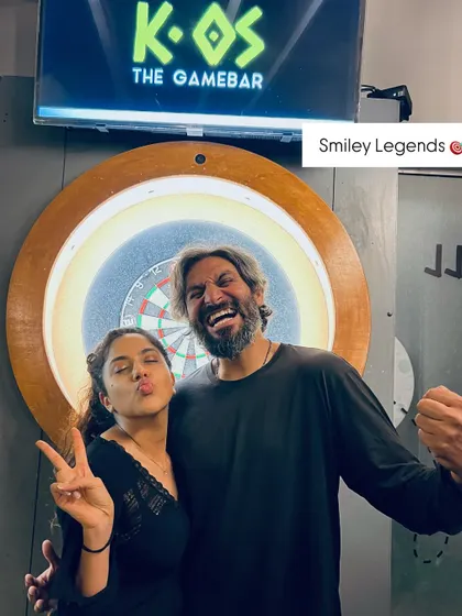 These smiley legends are having a blast by the dartboard. It's a great spot for a photo op after a competitive game during our Karaoke Fridays.