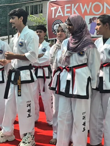 My black belt and red belt students standing on stage during a demonstration.