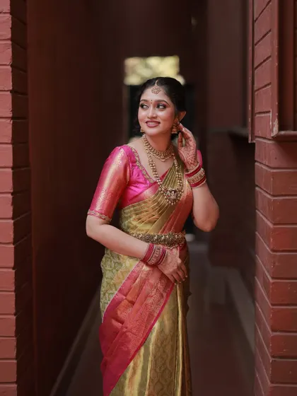 This full-length shot shows how the entire look comes together. The makeup, hair, saree, and jewellery are all in perfect harmony, creating a stunning bridal portrait.