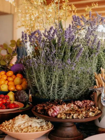A beautiful grazing table display featuring fresh lavender, artisanal breads, and dips. The arrangement is both a feast for the eyes and the palate.