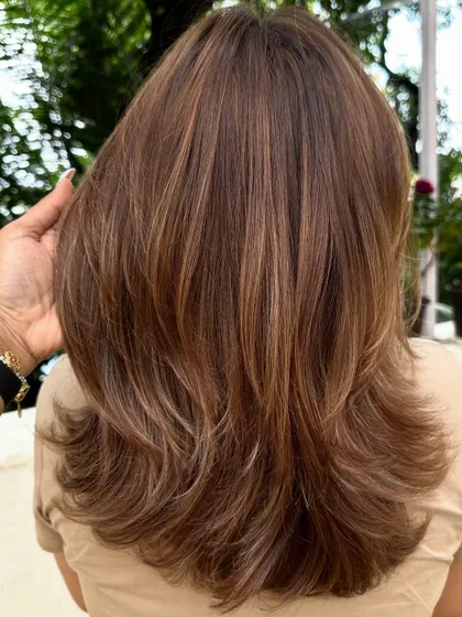 This shot highlights the feathered ends of the layered cut, which helps in creating a soft, airy look.