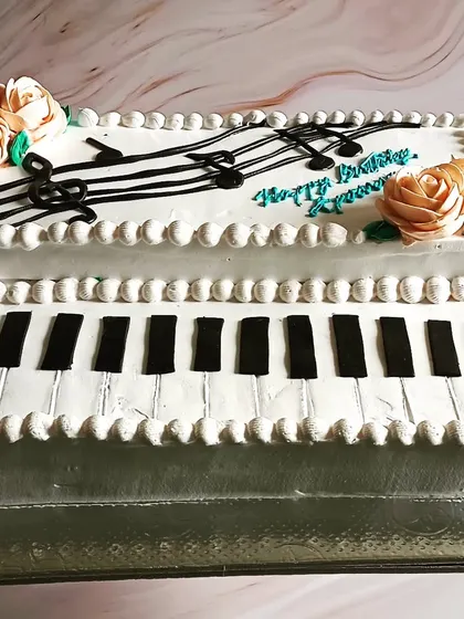 A keyboard-themed cake for a little musician, with raspberry flavour and detailed piano keys.