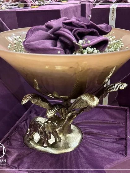 A side view of the Elephant Bowl, showing the intricate details of the elephant and palm tree base. It's a piece that seamlessly blends durability with style.