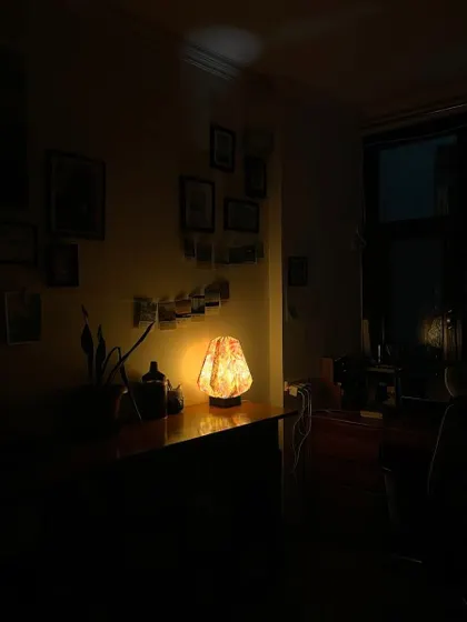 My studio at night, lit by a single warm lamp. It's a peaceful, magical space where I can create without distractions.
