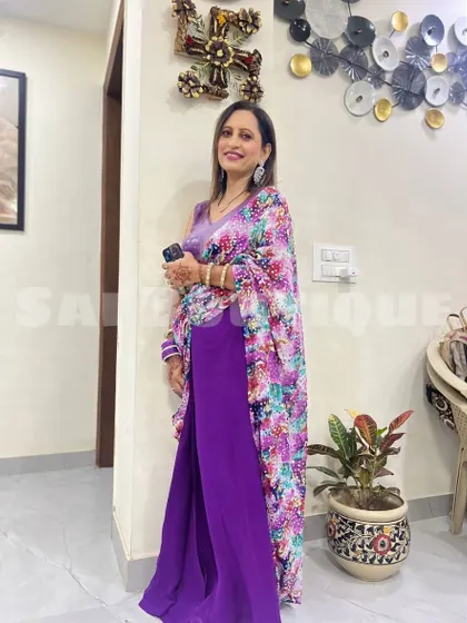 A client looking elegant in a purple jumpsuit with a floral print cape. This is a great example of a custom Indo-western outfit for any occasion.