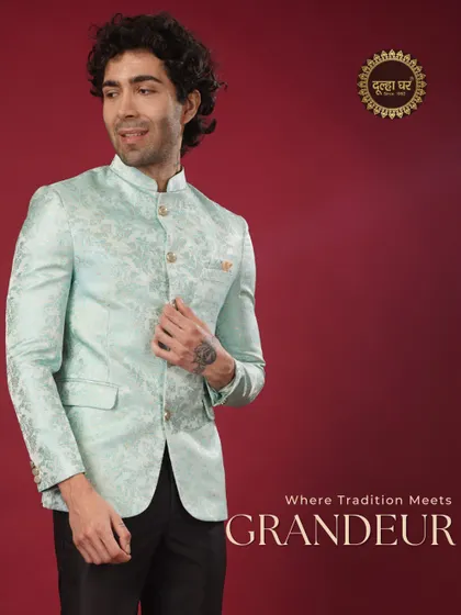 Where tradition meets grandeur. A model in a pastel blue brocade Bandhgala jacket, exuding a cool and sophisticated charm.