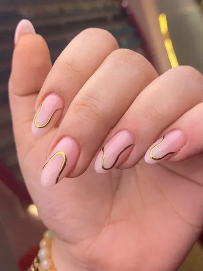 Simple, elegant, and modern. This design uses a fine gold line to create a fluid, organic shape on a sheer pink base.