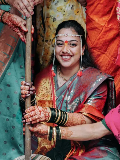 A candid shot of the bride smiling during a traditional Haldi ritual.