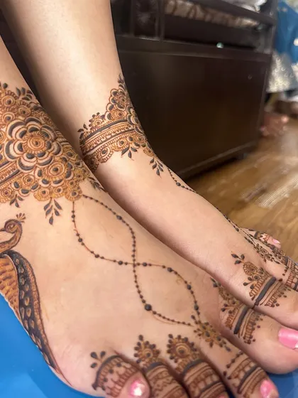 A graceful peacock design for the feet, with a delicate chain pattern connecting the ankle piece to the toes.