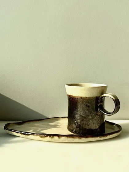 The complete set: a mug and plate from the Shibui Collection. This tableware is designed to bring a touch of handcrafted beauty to your home.