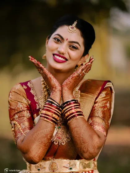 Such a joyful and expressive photo. This bride is showing off her beautiful henna and her radiant smile, framed by her flawless makeup.