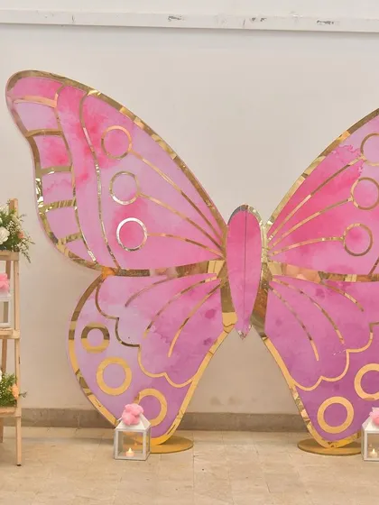 This giant butterfly makes for a fantastic photo booth. Guests can pose in front of it for memorable pictures that fit the party's theme perfectly.
