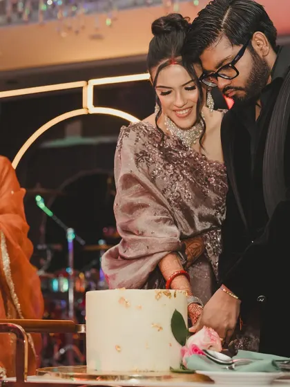 The cake-cutting moment during the masquerade after-party. A sweet moment amidst all the high-energy dancing and music.