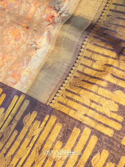 The interplay of the printed body and the woven brass zari border.
