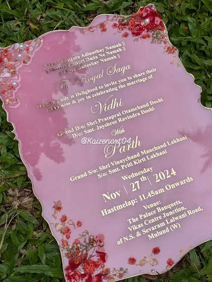 A collection of wedding art pieces, including a resin Kankotri and a flower preservation keepsake. Each item is handcrafted to be a lasting memento of a couple's special day.
