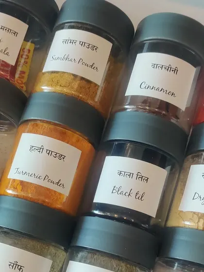 These spice jars feature my custom bilingual labels. Having both Hindi and English names, like "Haldi Powder" and "Turmeric Powder," ensures there is no confusion for your staff in the kitchen.