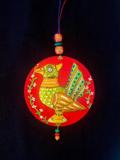 A charming wall hanging featuring a bird painted in a folk-art style. These small, decorative pieces are ideal for gifting and come in a price range of 350-850.