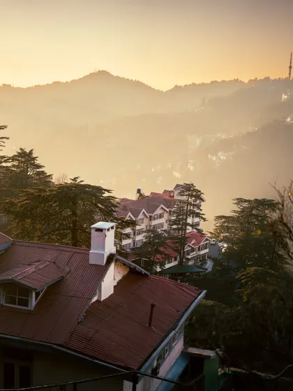 A hazy morning in Shimla, with the layers of hills fading into the distance. The soft light creates a gentle and serene mood.