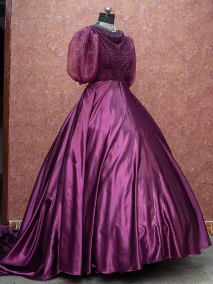 A regal purple gown with puff sleeves and a full, flowing skirt. This is an excellent rental choice for a pre-wedding shoot or a formal evening event.