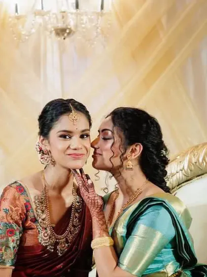 A sweet, candid moment between sisters. The makeup is designed to look soft and beautiful even in close-up, emotional shots.