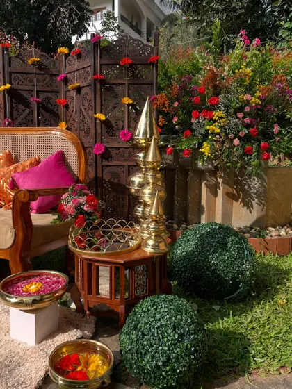 Another angle of the beautiful Mehandi seating area. The combination of the carved screen, the cane sofa, and the lush greenery creates a perfect blend of tradition and nature.
