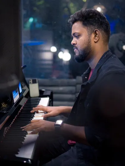 A pianist lost in the melody, with the city lights twinkling outside. It's a beautiful setting for an evening of live music.