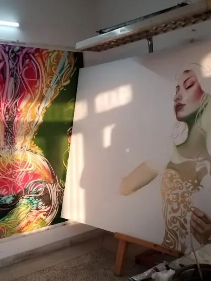A glimpse of two paintings side-by-side in my studio. On the right, a new piece is just beginning with a pencil sketch on canvas, while another completed work hangs nearby.