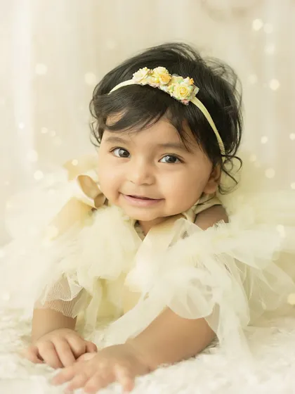A sweet and engaging smile. This close-up shot is all about her happy expression and bright eyes.