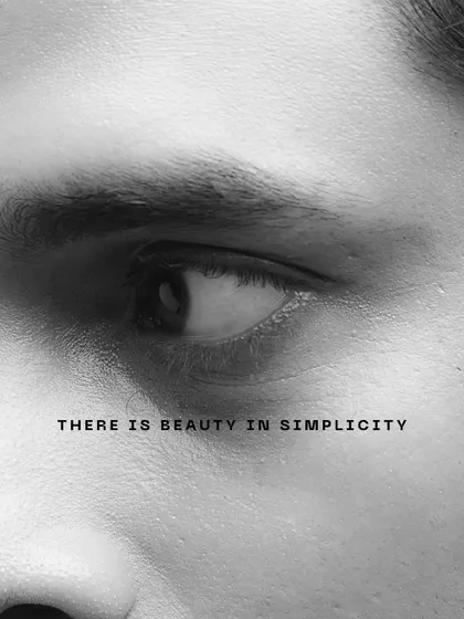 A minimalist black and white close-up of an eye. This fine art shot uses simplicity and text to convey a message, focusing on the beauty in simple forms.