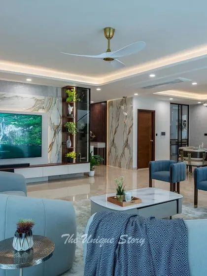 This shot captures the grandeur of the living and dining space, with the elegant furniture arrangement and luxurious materials. The design balances open space with defined functional areas for a harmonious living experience.