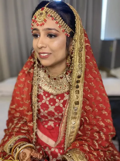 The complete look for my stunning Punjabi bride. Her traditional attire, intricate jewelry, and my classic makeup artistry come together for a look of pure elegance.