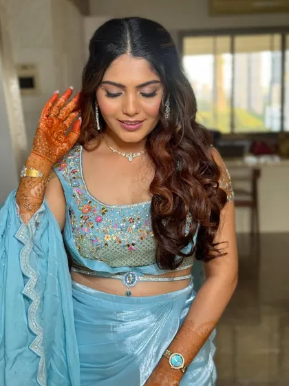 A candid moment showing the soft texture of the waves. This hairstyle is perfect for anyone wanting a glamorous look for a wedding or party.