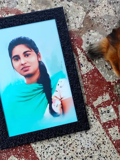 The framed digital painting, seen here with my curious dog. This portrait was a commission, and I focused on creating a soft, painterly effect to honor the subject.