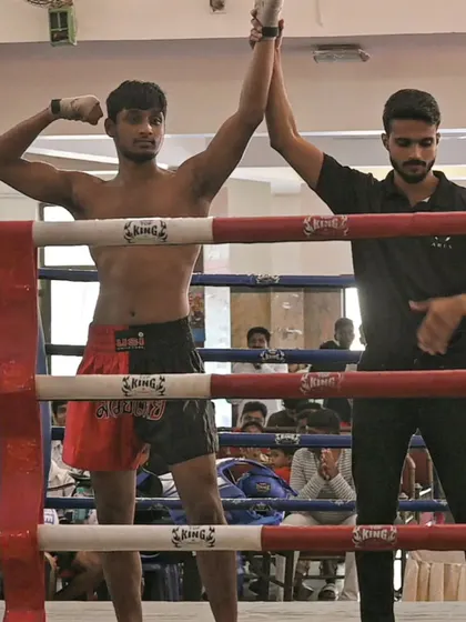 A well-earned victory pose after a tough fight in the state championship ring.