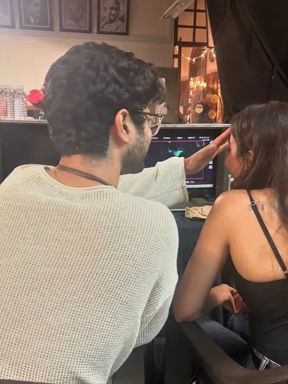 On set, checking the monitor to see how the costumes and styling translate on camera. This collaborative process is key to getting the final look just right.