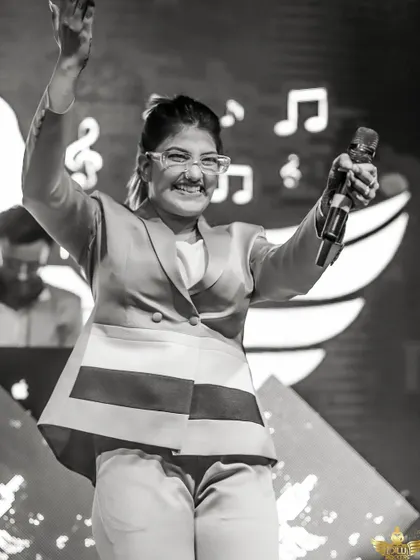 A happy, candid moment from our female vocalist on stage. Her infectious smile and energy spread through the entire audience.