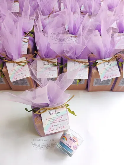 An army of baby shower return gifts, all beautifully wrapped in lilac net. This shows my capacity to handle bulk orders while maintaining a high level of personalization and quality for each gift.