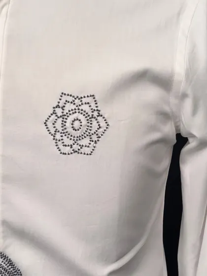 A close-up of the geometric floral motif on the abstract-figurative shirt. This small detail adds another layer of artistry to the piece.