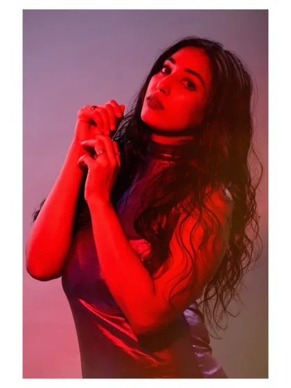 A portrait using colored gels to paint with light. The red light casts dramatic shadows and creates a bold, emotional atmosphere that is both modern and intense.