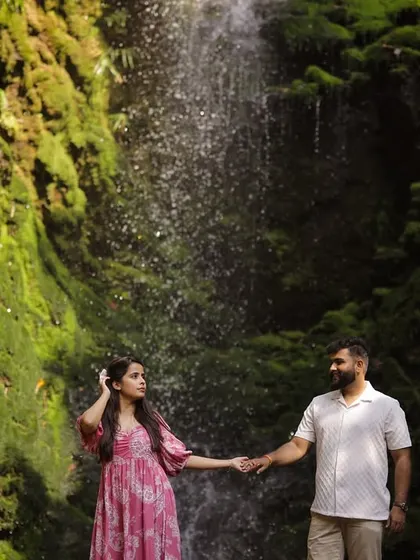 Holding hands against the backdrop of a stunning waterfall, this shot is all about connection. I guide couples into poses that feel natural, capturing the bond they share in a beautiful setting.